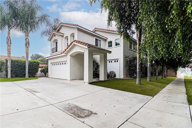 mediterranean / spanish home with a front lawn and a garage