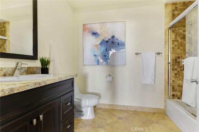 full bathroom featuring toilet, enclosed tub / shower combo, and vanity