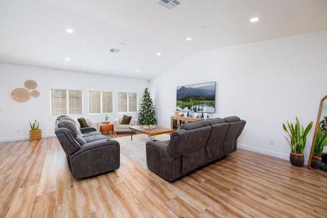 living room featuring light hardwood / wood-style flooring and lofted ceiling