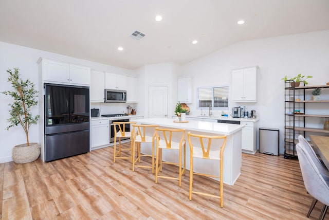 kitchen featuring white cabinetry, appliances with stainless steel finishes, and a kitchen island