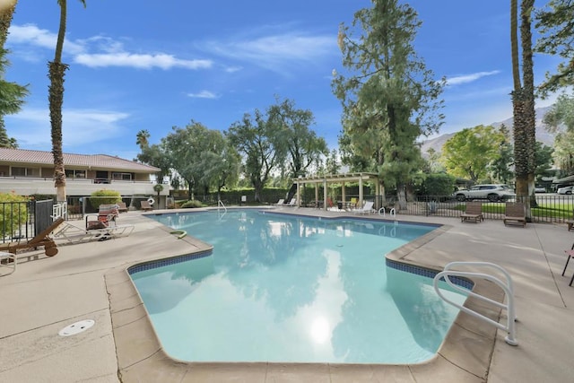 view of swimming pool featuring a patio area and a mountain view