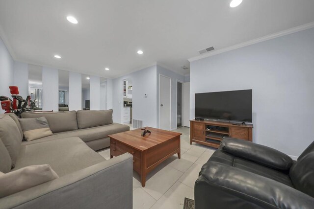 living room with light tile patterned floors and ornamental molding