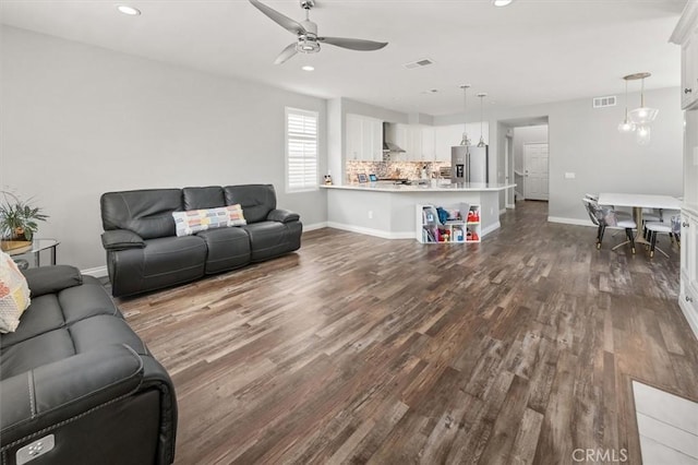 living room with ceiling fan and wood-type flooring