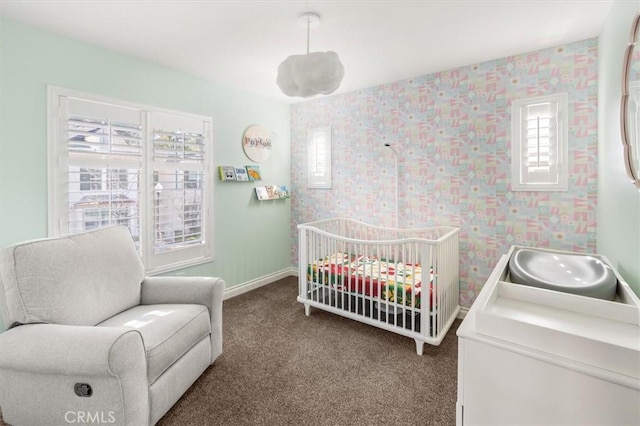 bedroom with carpet floors, sink, and a crib