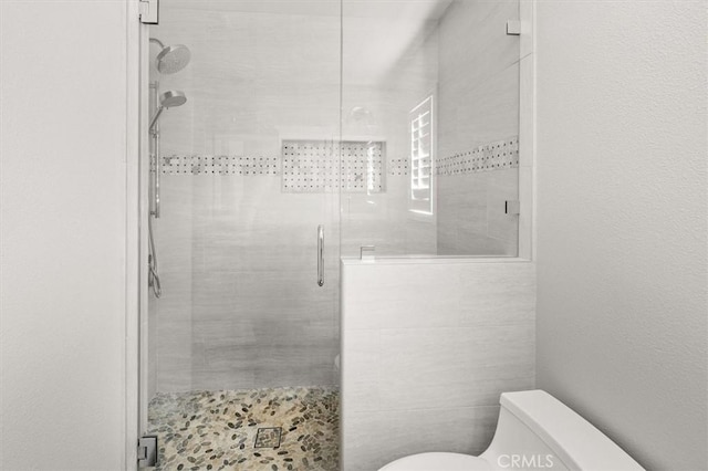 bathroom with toilet, tile walls, and an enclosed shower