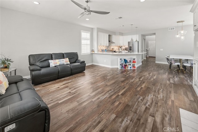 living room featuring ceiling fan and hardwood / wood-style floors