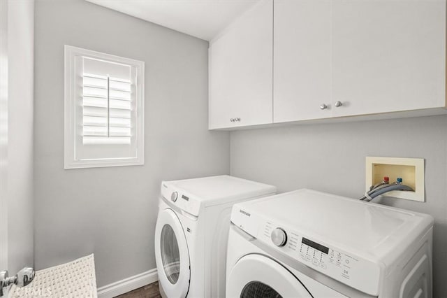 washroom with washing machine and clothes dryer and cabinets