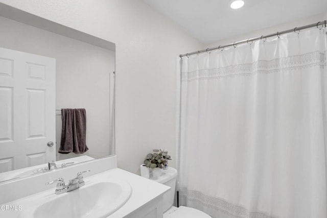 bathroom featuring toilet and vanity