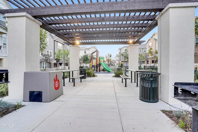 view of patio / terrace featuring a playground and a pergola