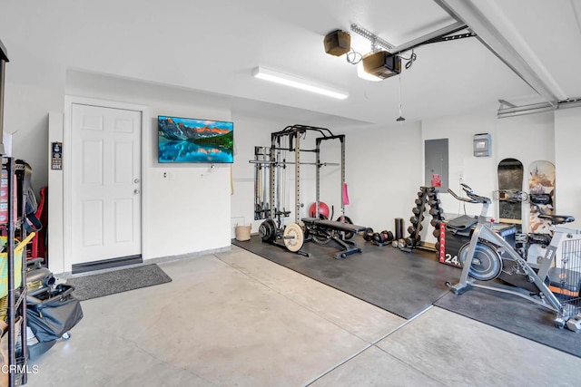 garage featuring electric panel and a garage door opener