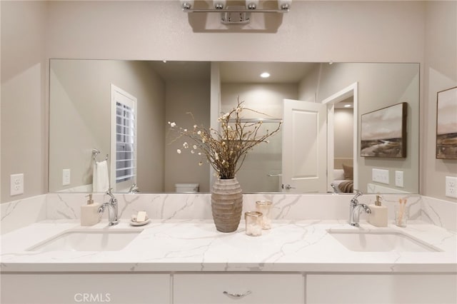 bathroom with toilet and vanity