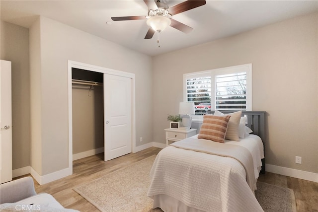 bedroom with ceiling fan, a closet, and light hardwood / wood-style flooring