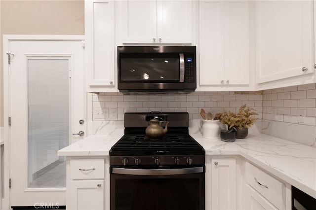 kitchen with white cabinetry, decorative backsplash, and stainless steel gas stove