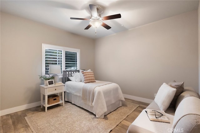 bedroom with ceiling fan and light hardwood / wood-style flooring