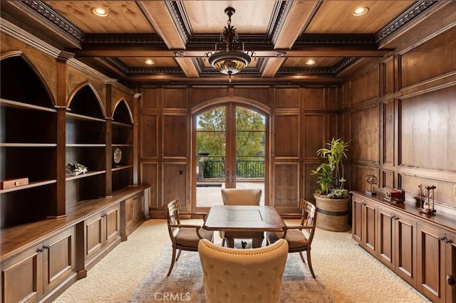 interior space featuring wooden ceiling, light carpet, ornamental molding, and wooden walls