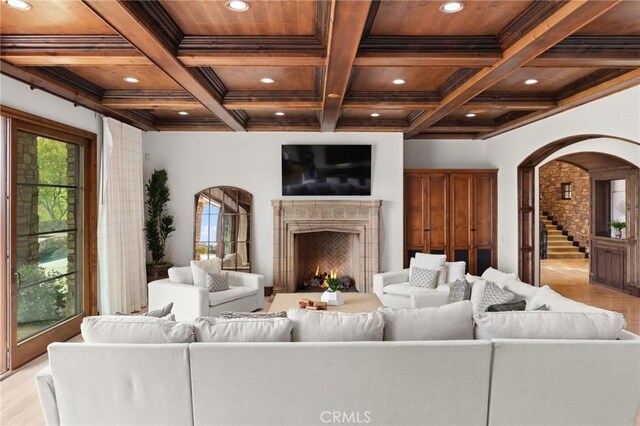 living room featuring wooden ceiling, ornamental molding, coffered ceiling, and beamed ceiling