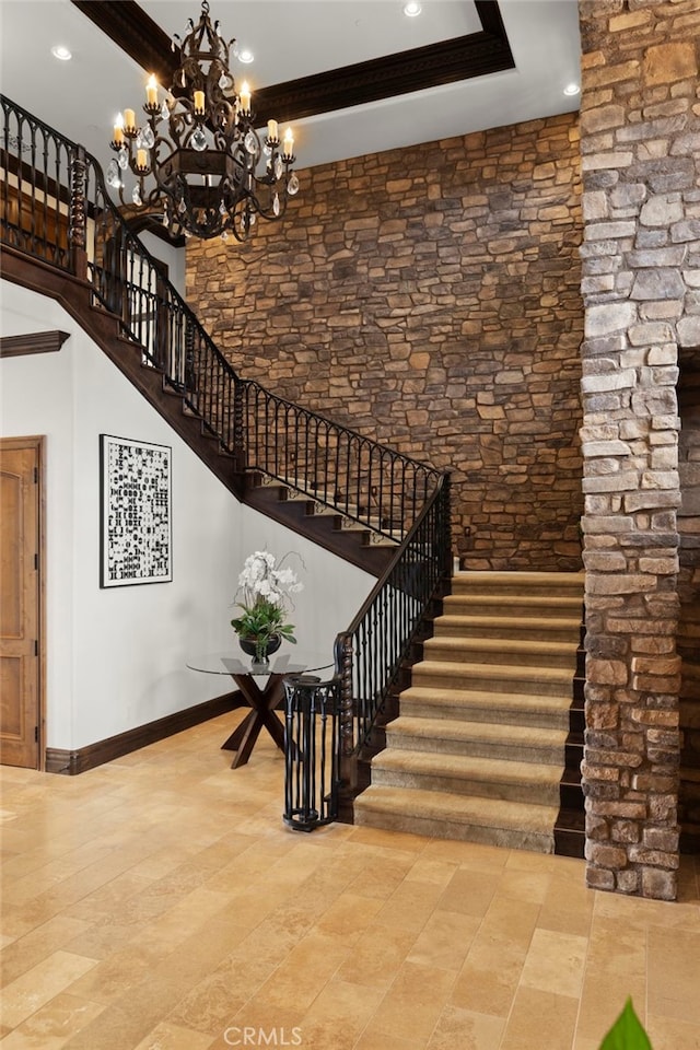 stairs featuring crown molding and a chandelier