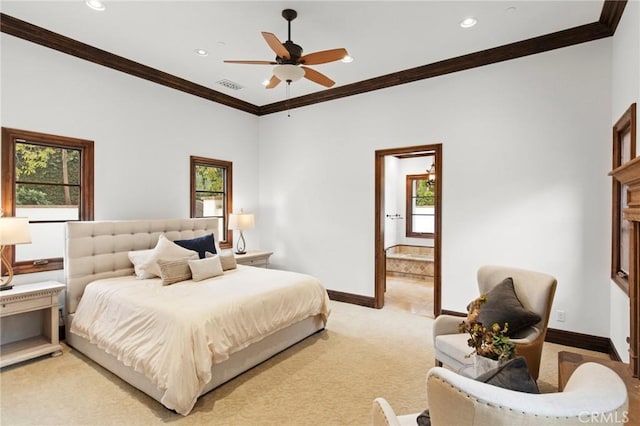 carpeted bedroom with ceiling fan, multiple windows, ornamental molding, and connected bathroom