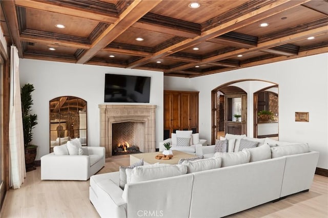 living room featuring beam ceiling, light wood-type flooring, wood ceiling, and coffered ceiling