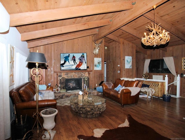 living room featuring wood-type flooring, a stone fireplace, an inviting chandelier, vaulted ceiling with beams, and wooden ceiling