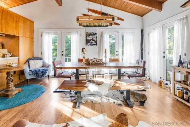 dining space featuring wood ceiling, hardwood / wood-style floors, french doors, and vaulted ceiling with beams