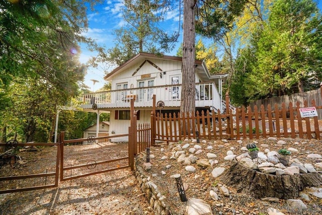 view of front of property featuring a storage shed and a deck