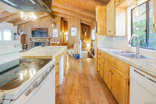 kitchen featuring light hardwood / wood-style floors, white appliances, a fireplace, vaulted ceiling with beams, and sink