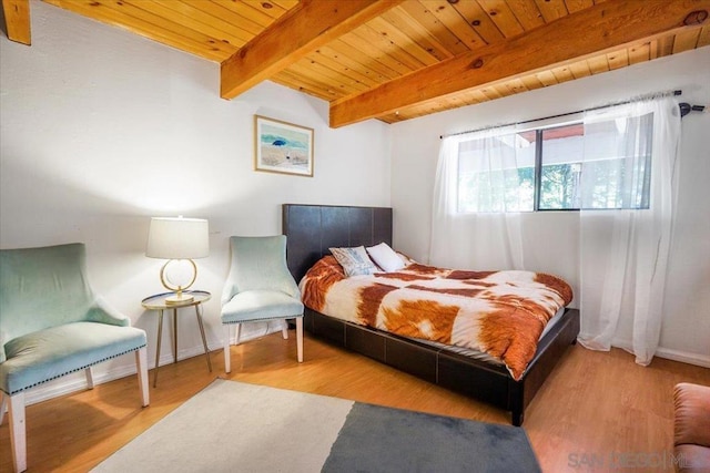 bedroom with wood ceiling, beamed ceiling, and light hardwood / wood-style floors