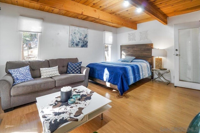 bedroom featuring wood ceiling, light hardwood / wood-style flooring, and beamed ceiling