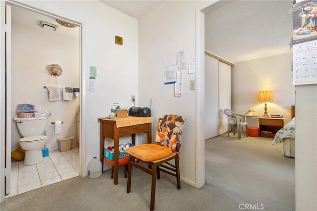 interior space featuring tile patterned floors and toilet