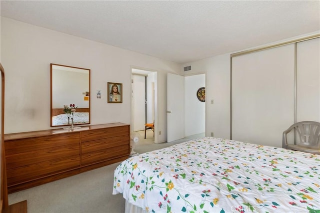 carpeted bedroom featuring a closet