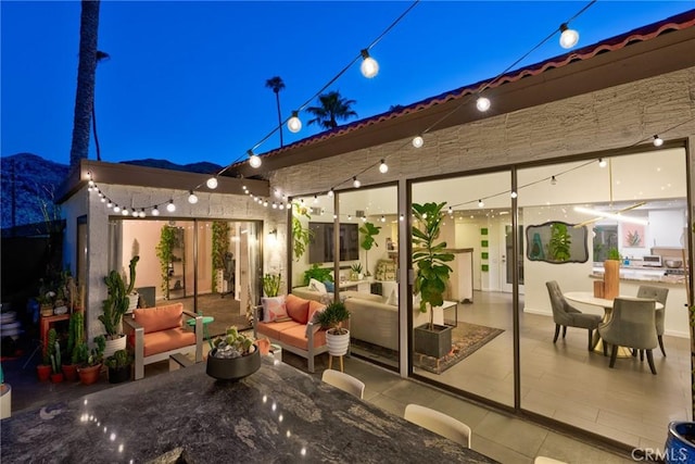 view of patio with an outdoor living space and a mountain view