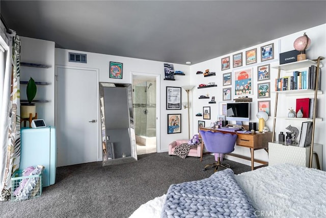 carpeted bedroom featuring connected bathroom and washer / dryer