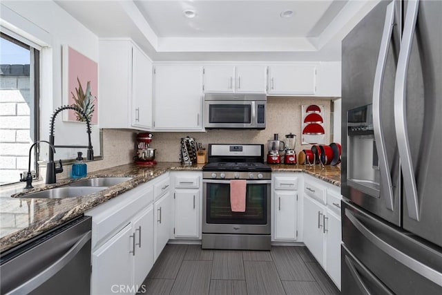 kitchen featuring white cabinets, sink, and stainless steel appliances