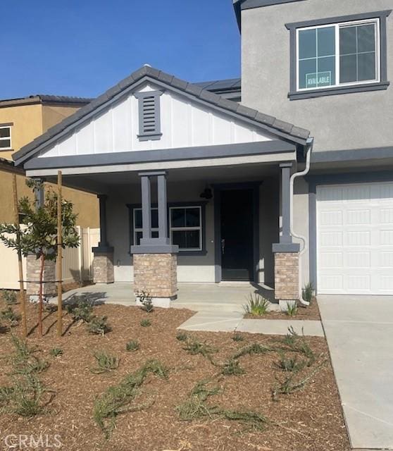 view of front of home with a porch and a garage