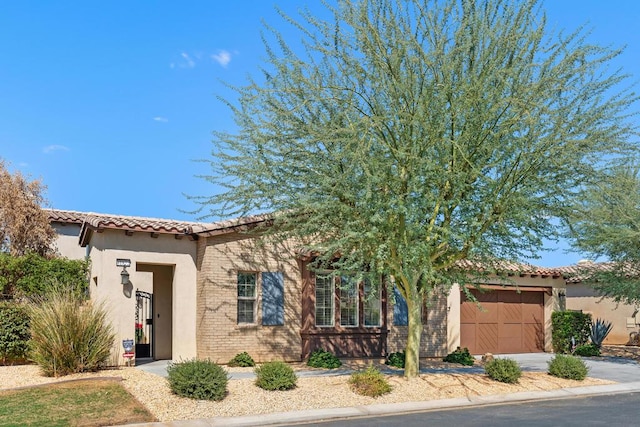 mediterranean / spanish-style home with a garage