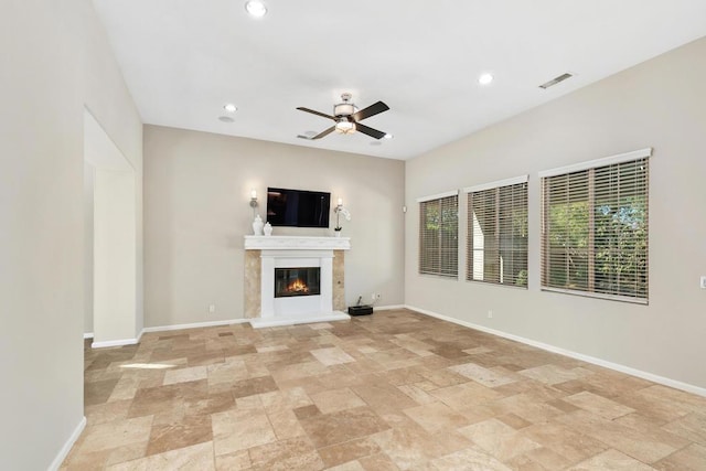 unfurnished living room with ceiling fan