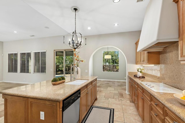 kitchen featuring custom exhaust hood, an island with sink, pendant lighting, stainless steel dishwasher, and sink