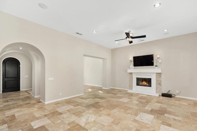 unfurnished living room featuring ceiling fan