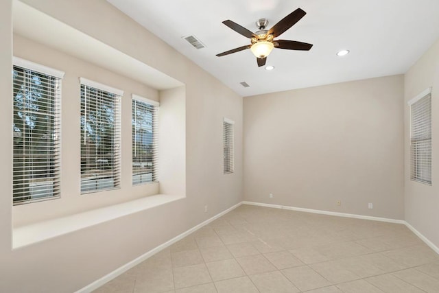 unfurnished room featuring ceiling fan, a healthy amount of sunlight, and light tile patterned flooring