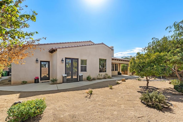 rear view of property featuring french doors