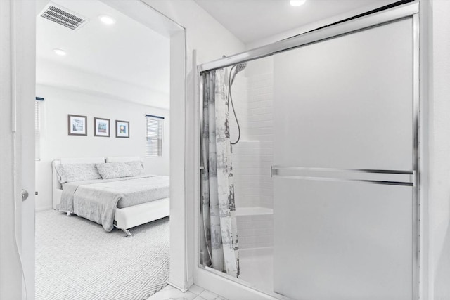 bathroom with a shower with door