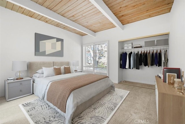 carpeted bedroom featuring a closet, beam ceiling, and wooden ceiling