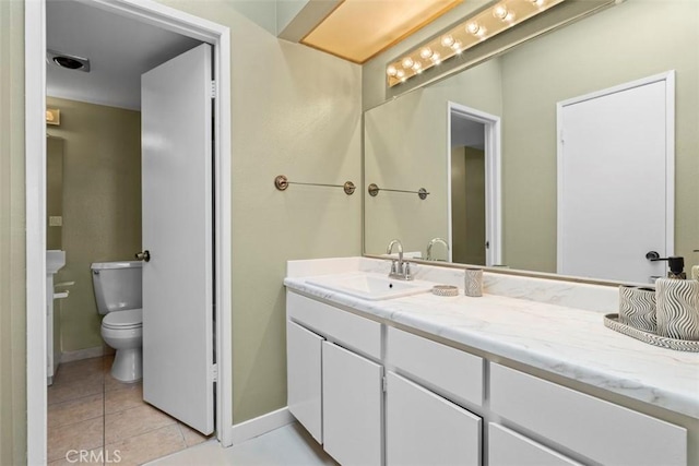 bathroom featuring toilet, vanity, and tile patterned floors