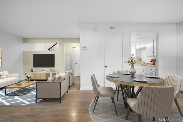 dining area with dark hardwood / wood-style flooring