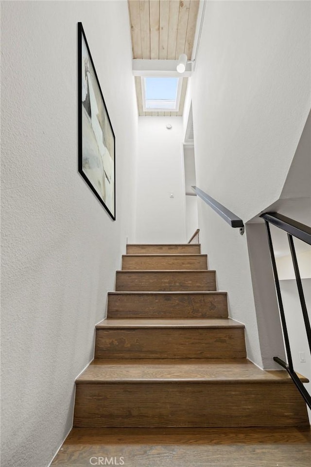 stairway with hardwood / wood-style floors