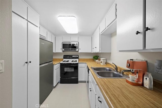 kitchen featuring sink, white cabinetry, and appliances with stainless steel finishes