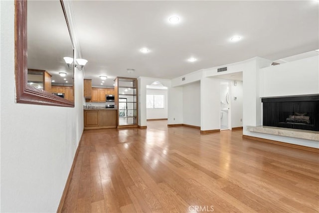 unfurnished living room with light hardwood / wood-style flooring