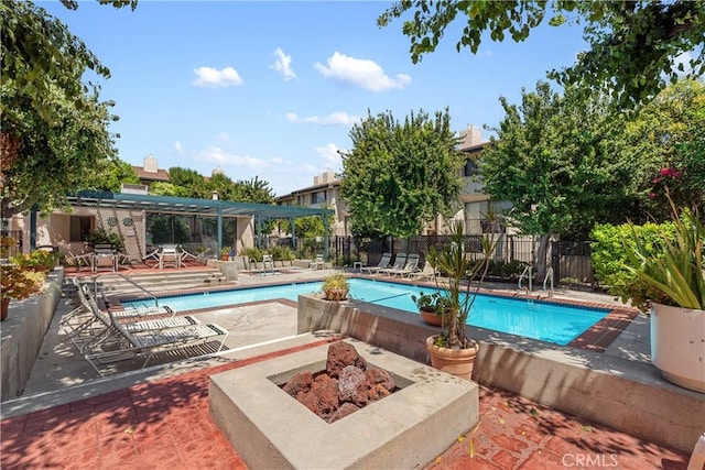 view of swimming pool featuring a patio area and an outdoor fire pit