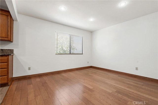 spare room with light hardwood / wood-style floors